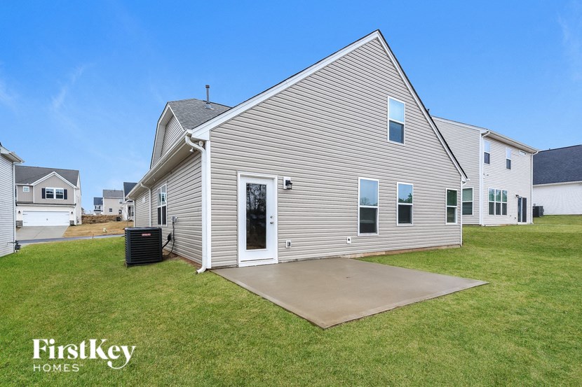 a white house with a yard and a driveway