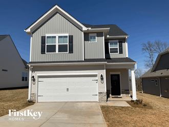 a new gray house with a white garage door