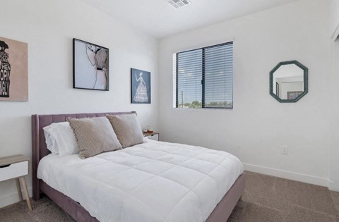 a bedroom with a bed and a window