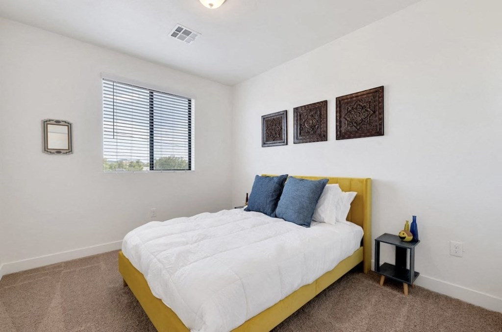 Furnished bedroom shown at Camelback Townhomes.