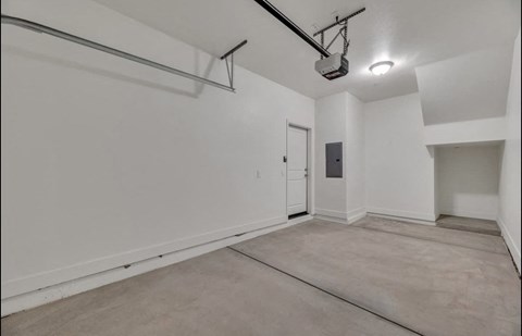the spacious living room and dining room of an empty studio apartment