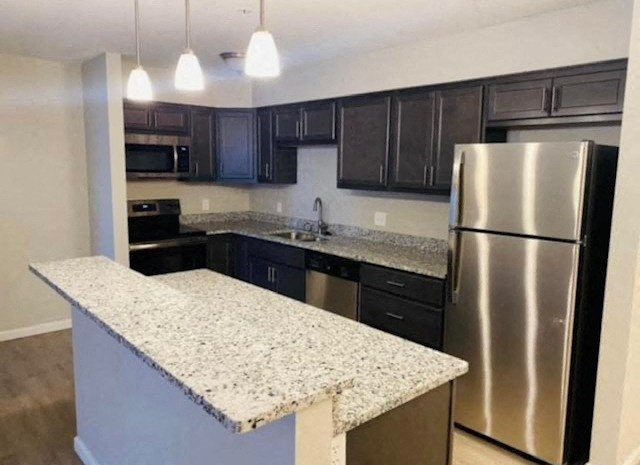 a kitchen with granite counter tops and stainless steel appliances