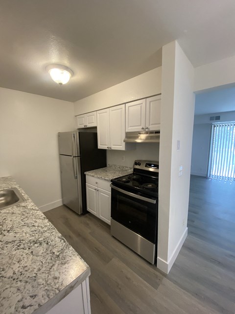 a kitchen with stainless steel appliances and marble counter tops