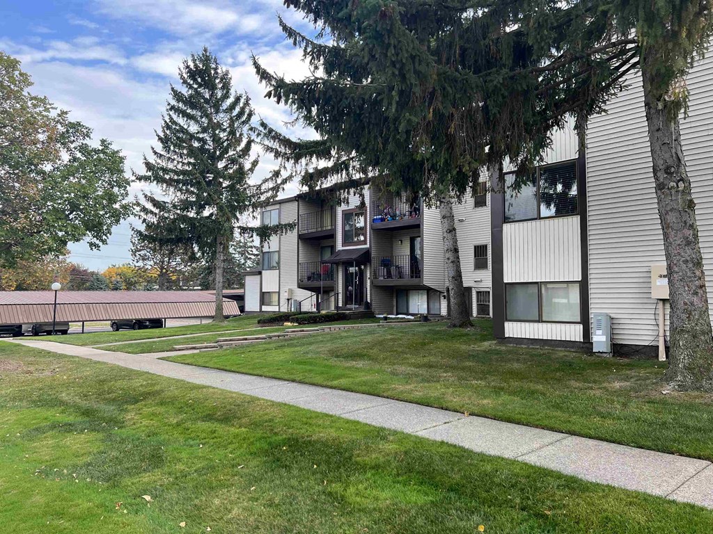 our apartments are located in a quiet area with a walkway and grass