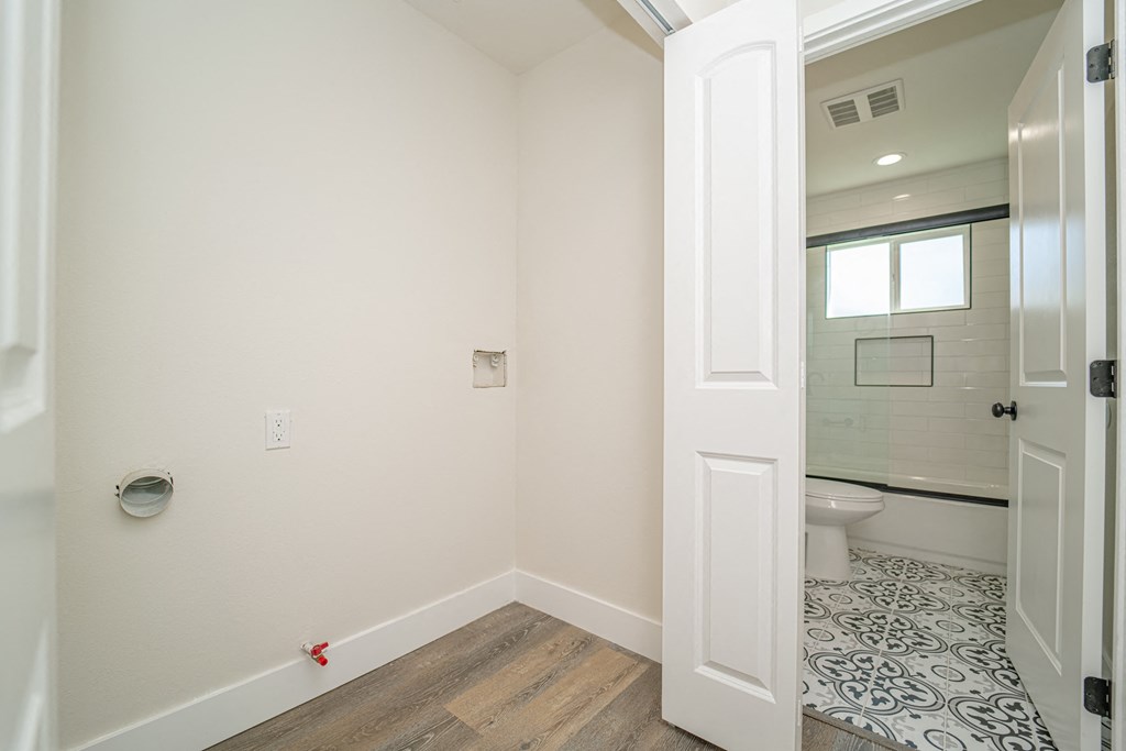 a bathroom with a white door and a toilet