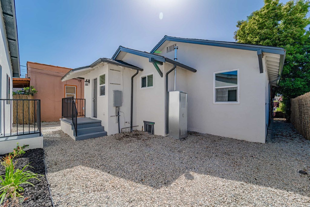a white house with a driveway and a staircase