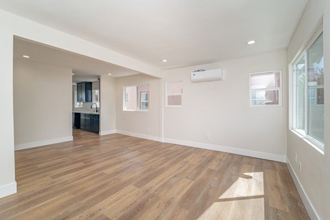 a living room with a hard wood floor and a window