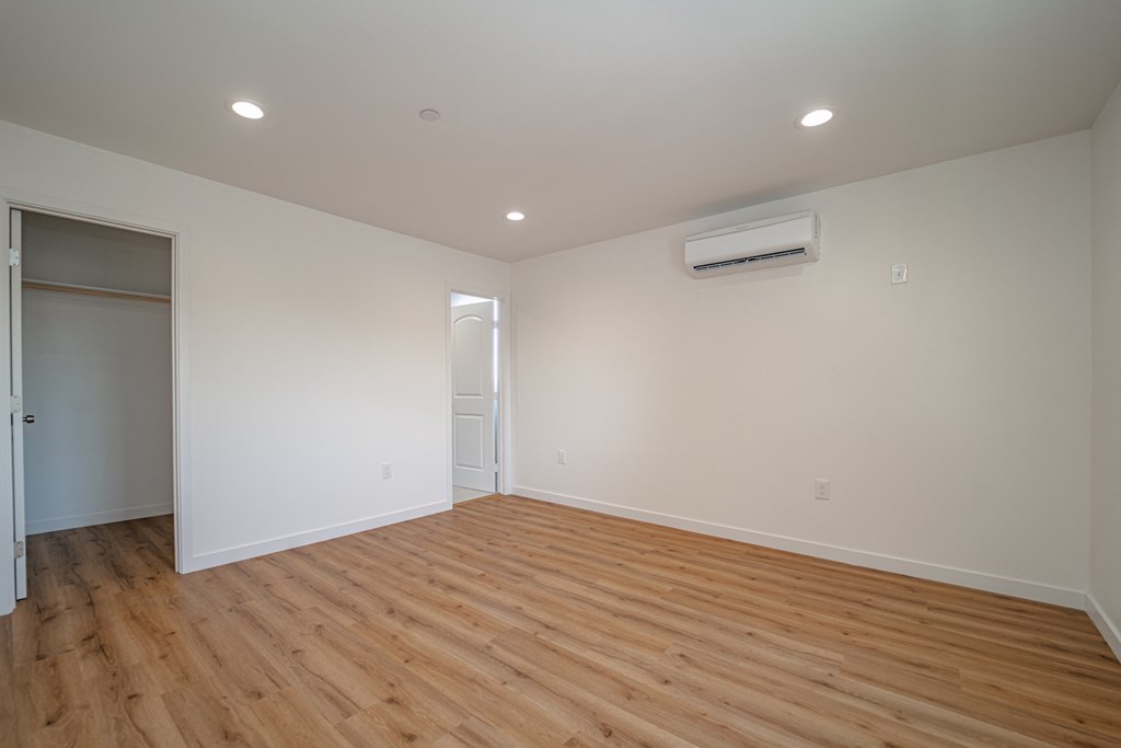 a living room with wood floors and white walls