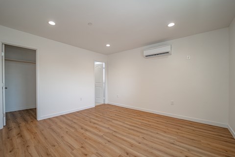a living room with wood floors and white walls