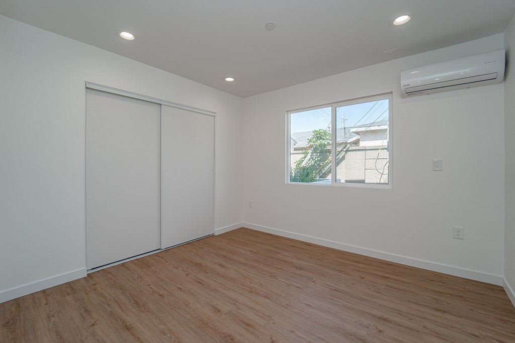 an empty room with white walls and a window
