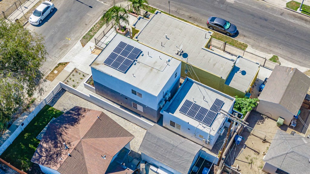 an aerial view of a building with solar panels on the roof