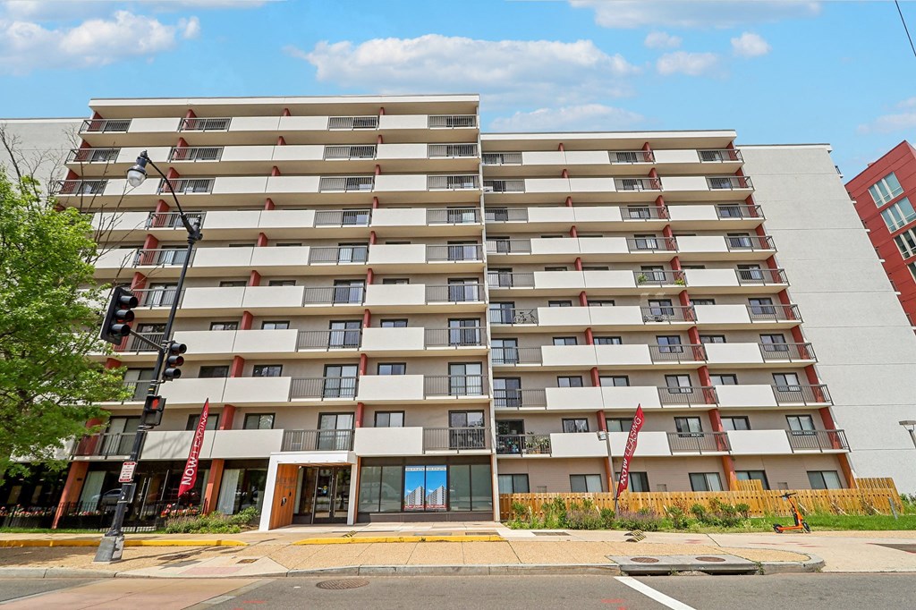 a large apartment building on the corner of a street