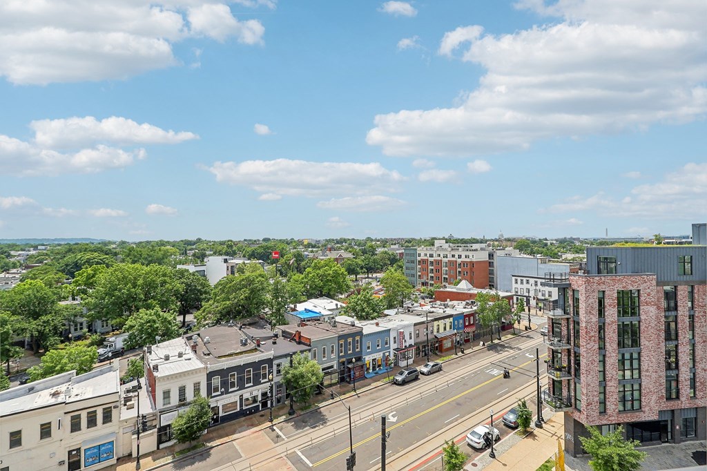an aerial view of a city street with buildings and trees