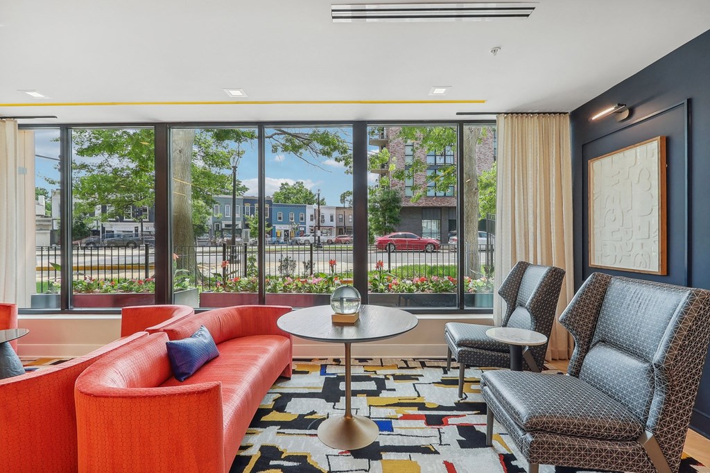 a living room with couches and chairs and a large window