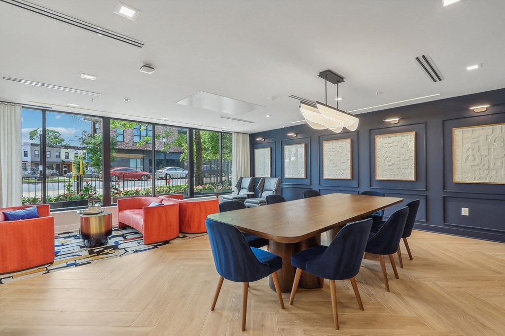 a dining room with a table and chairs and a large window
