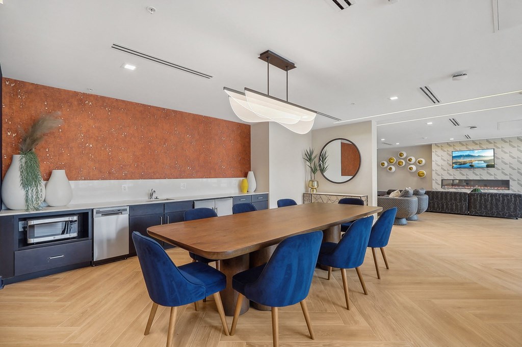 a dining room with a long wooden table and blue chairs