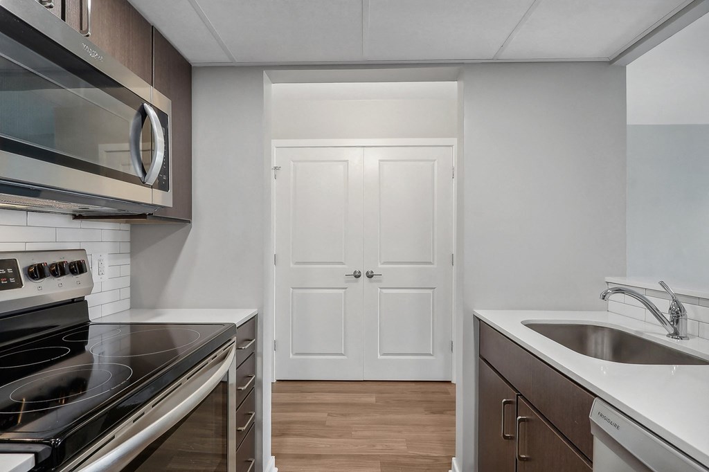 a kitchen with a sink and a stove and a door