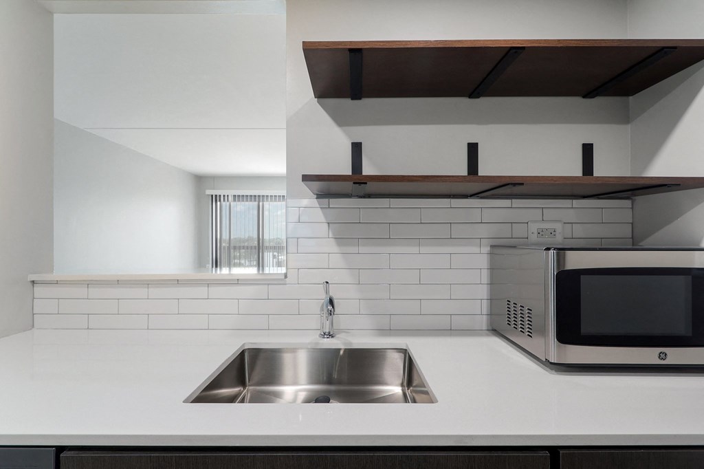 a kitchen with a sink and a microwave