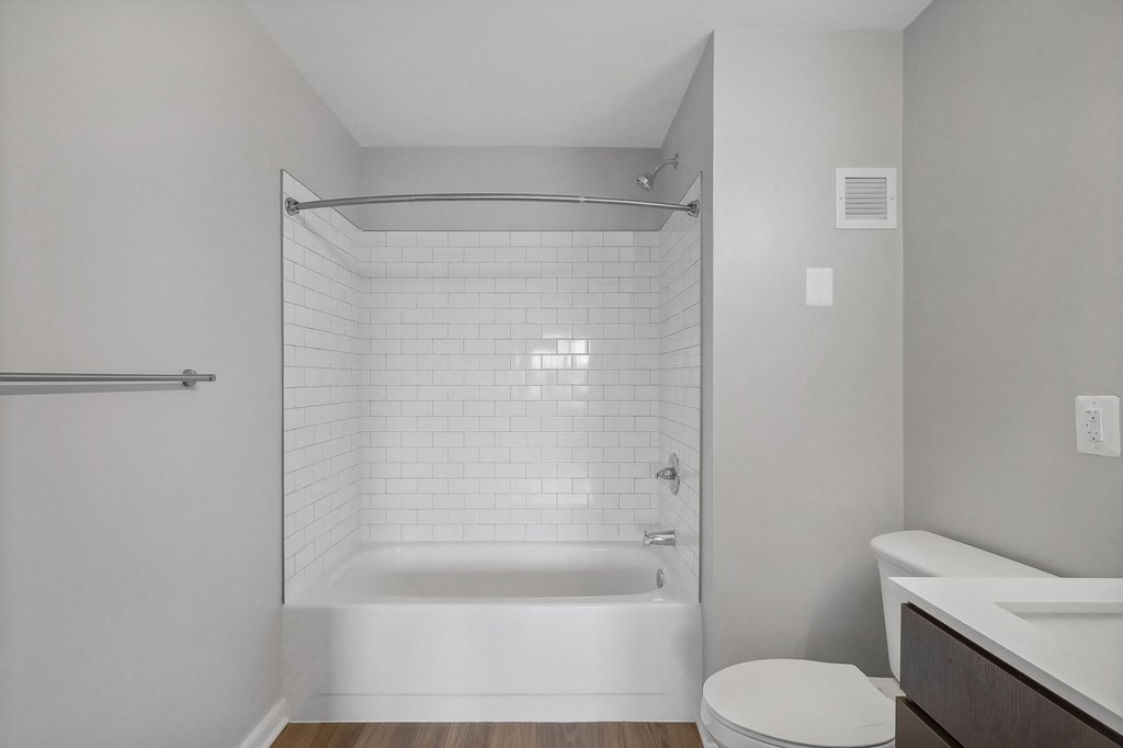 a bathroom with a shower and a toilet and a sink