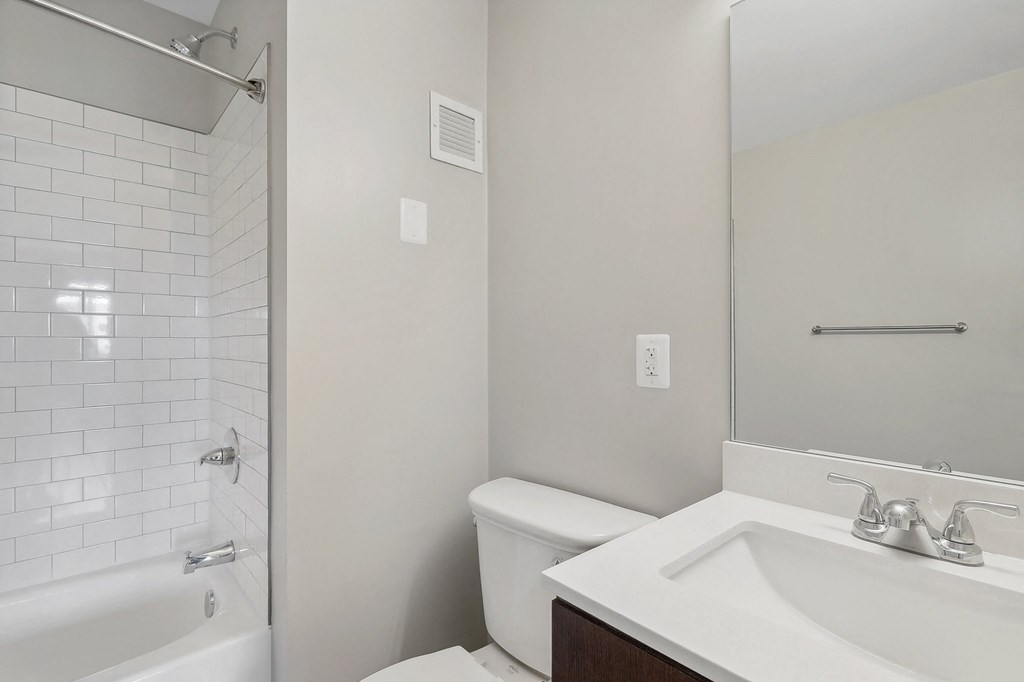 an empty bathroom with a sink toilet and shower