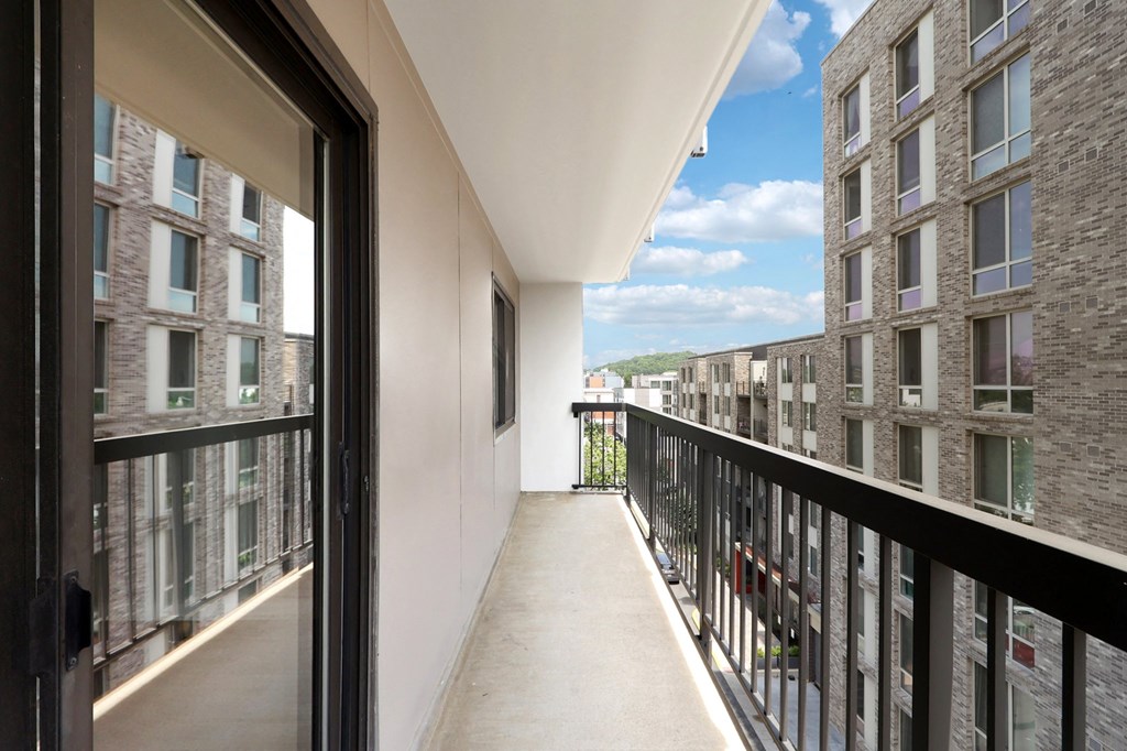 a balcony with a view of a building and a balcony railing