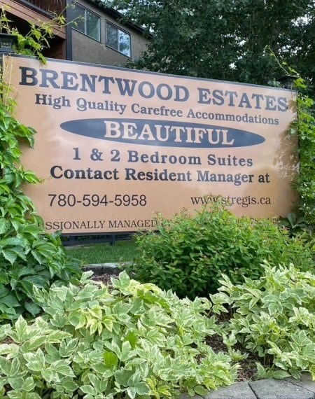 a sign estates in front of plants