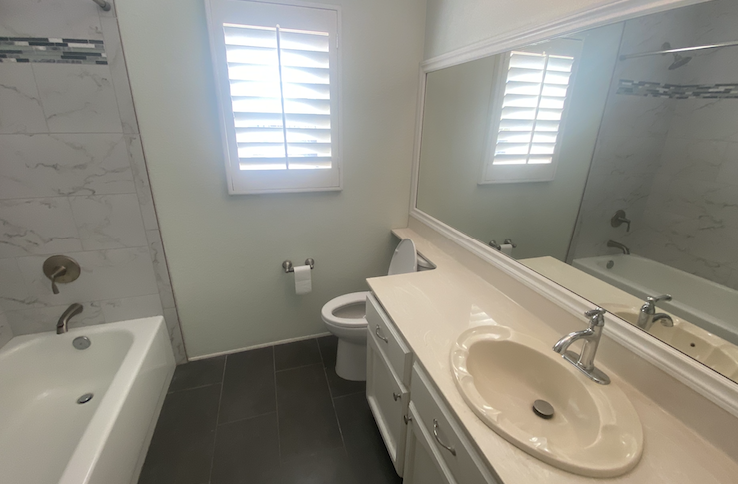a bathroom with a sink toilet and tub and a mirror