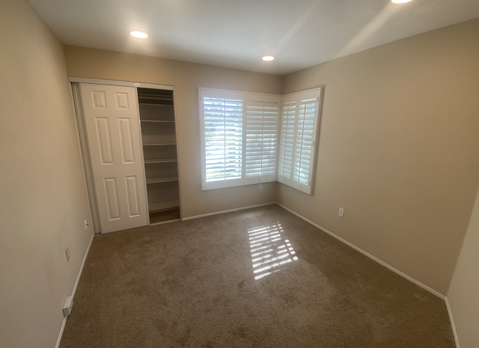 a empty room with a closet and a window