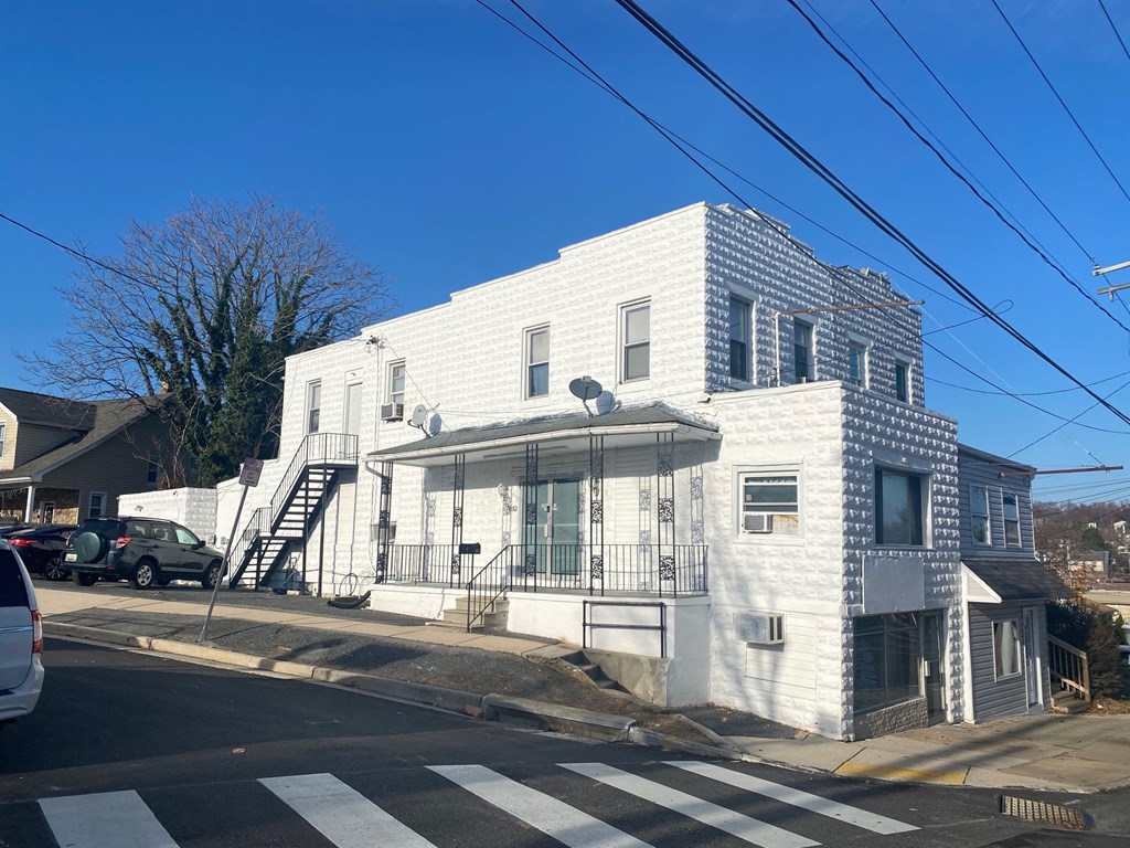 a white house on the corner of a street