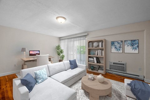 a living room with a white couch and a coffee table
