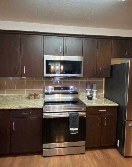 a kitchen with a stove and a microwave