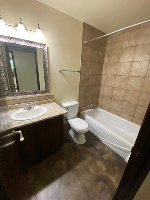 a bathroom with a sink toilet and a bath tub