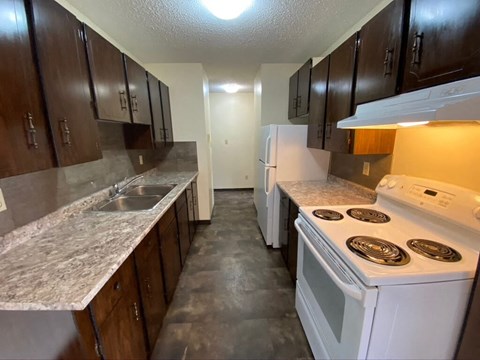a kitchen with a stove top oven and a sink