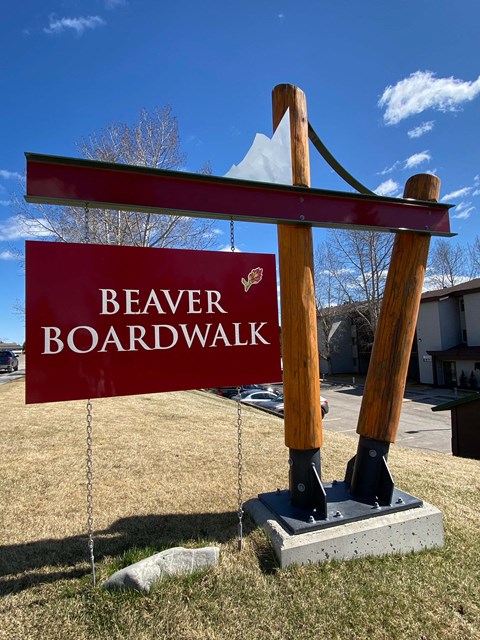 A sign that says Beaver Boardwalk is displayed on a pole.