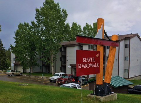 A sign that says Beaver Boardwalk stands in front of a building.