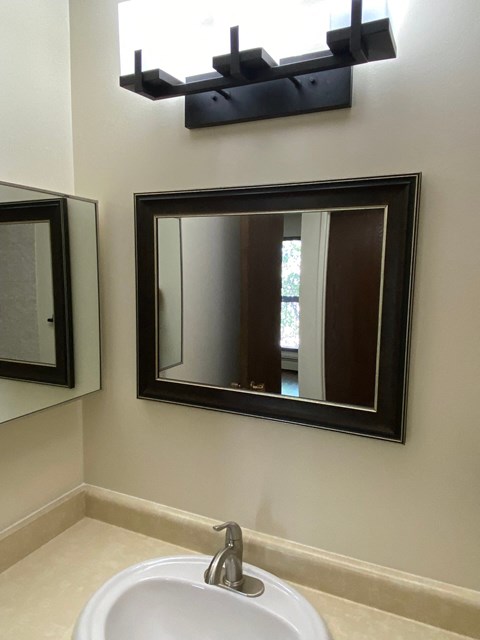 A bathroom with a sink and mirror.