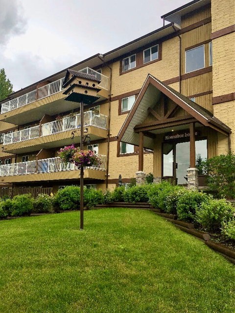 A building with a balcony and a sign that says "Harmony House".