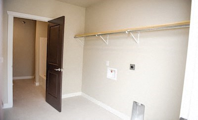 a white room with a door and a closet