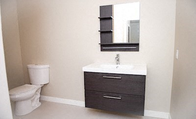 a bathroom with a toilet and a sink and a mirror