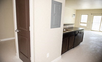 a kitchen with a sink and a open door