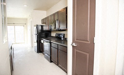 a kitchen with a stove and a refrigerator