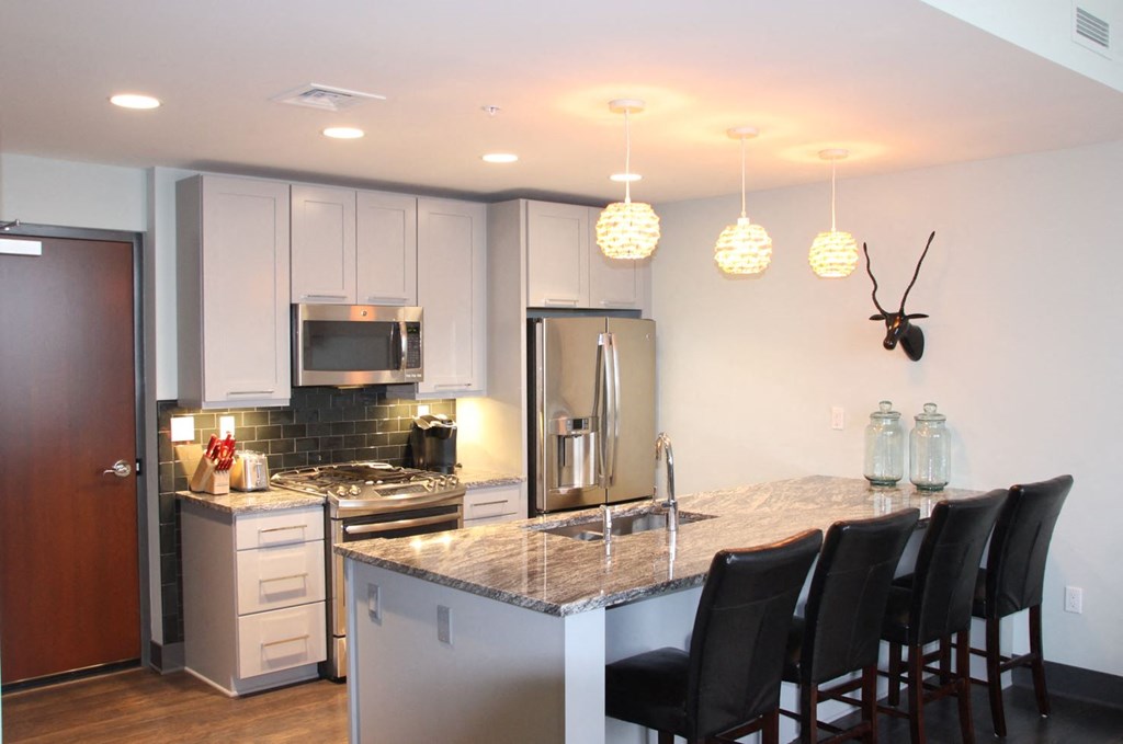 a kitchen with a marble counter top