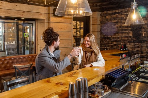 a man and a woman sitting at a bar
