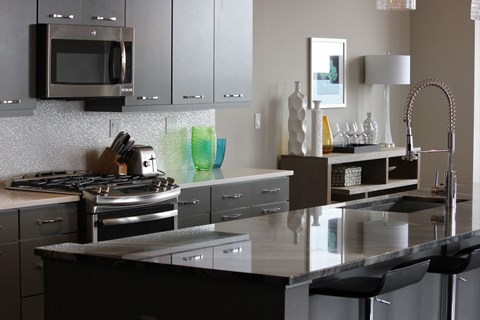 a modern kitchen with stainless steel appliances and counter tops