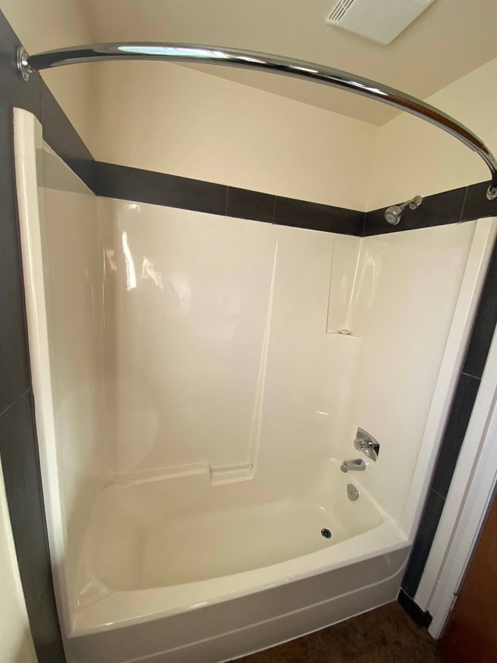 a shower in a bathroom with a shower curtain