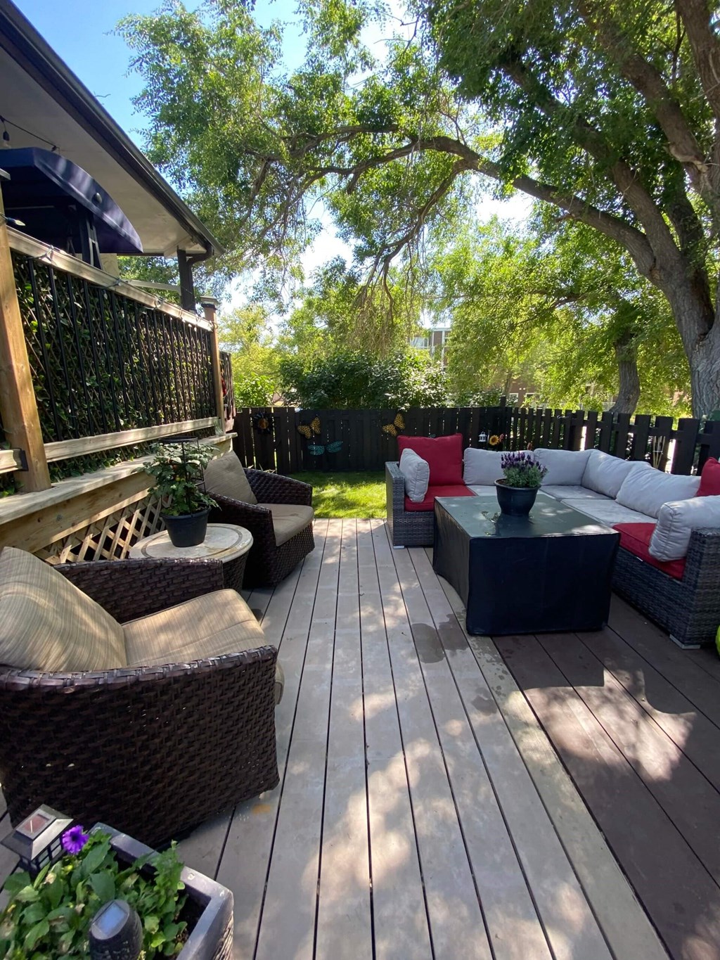 a backyard deck with couches and a table