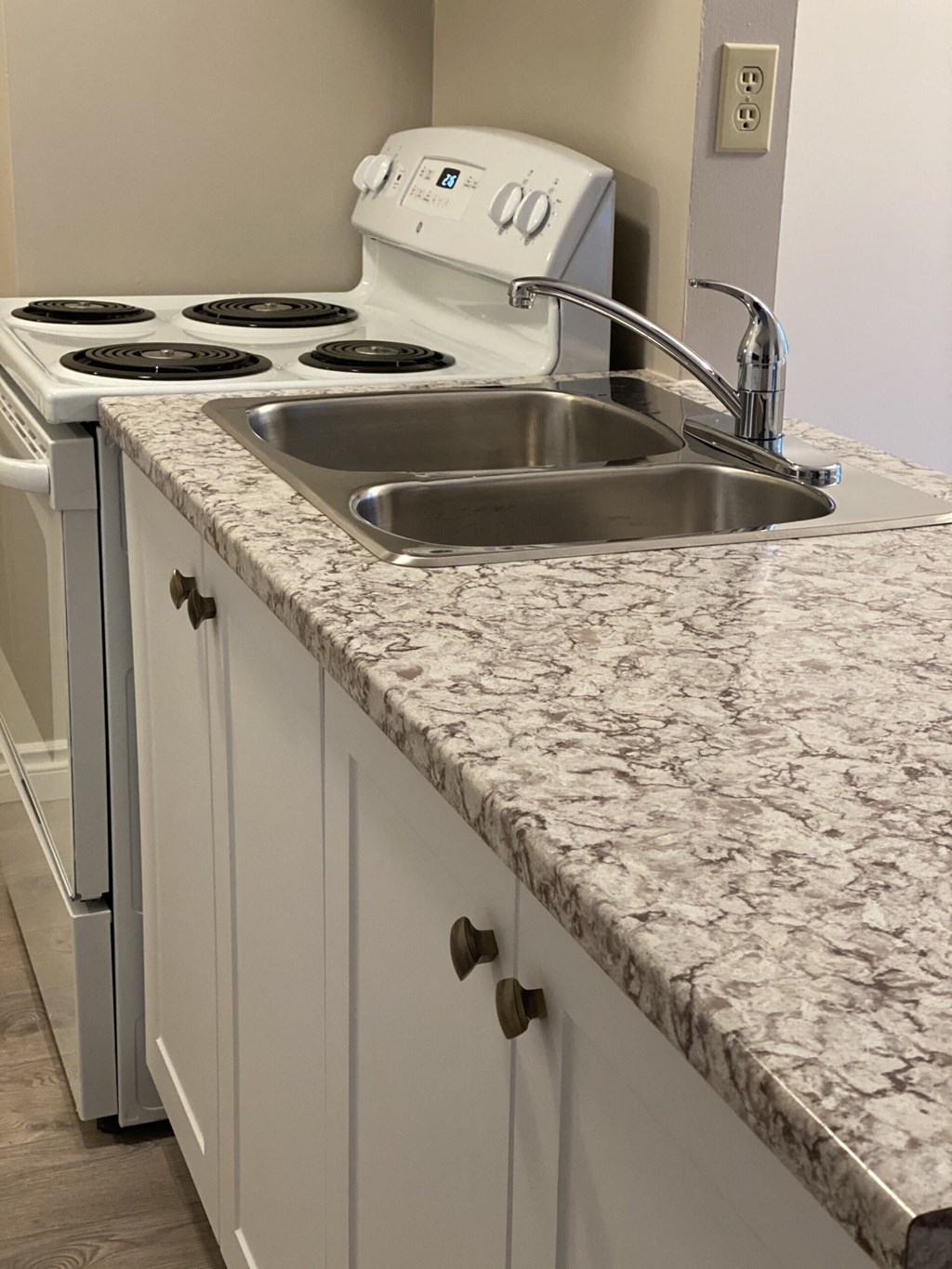 a kitchen with marble counter tops and a sink