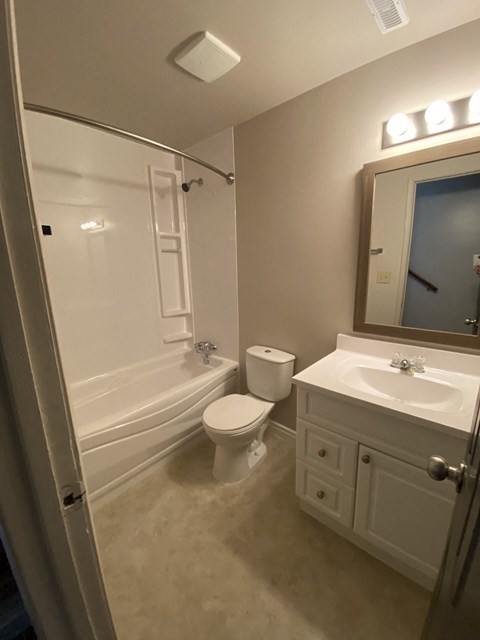a small bathroom with a toilet sink and shower