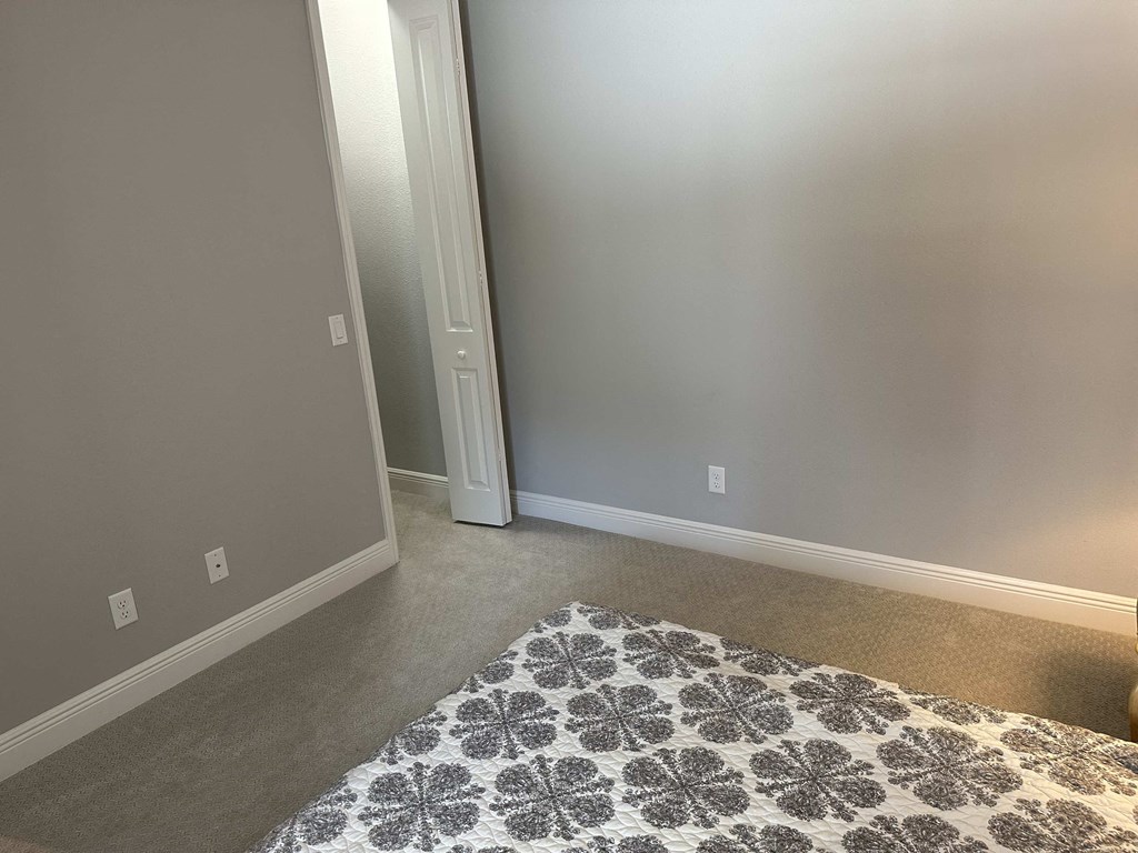 a living room with a rug and a door