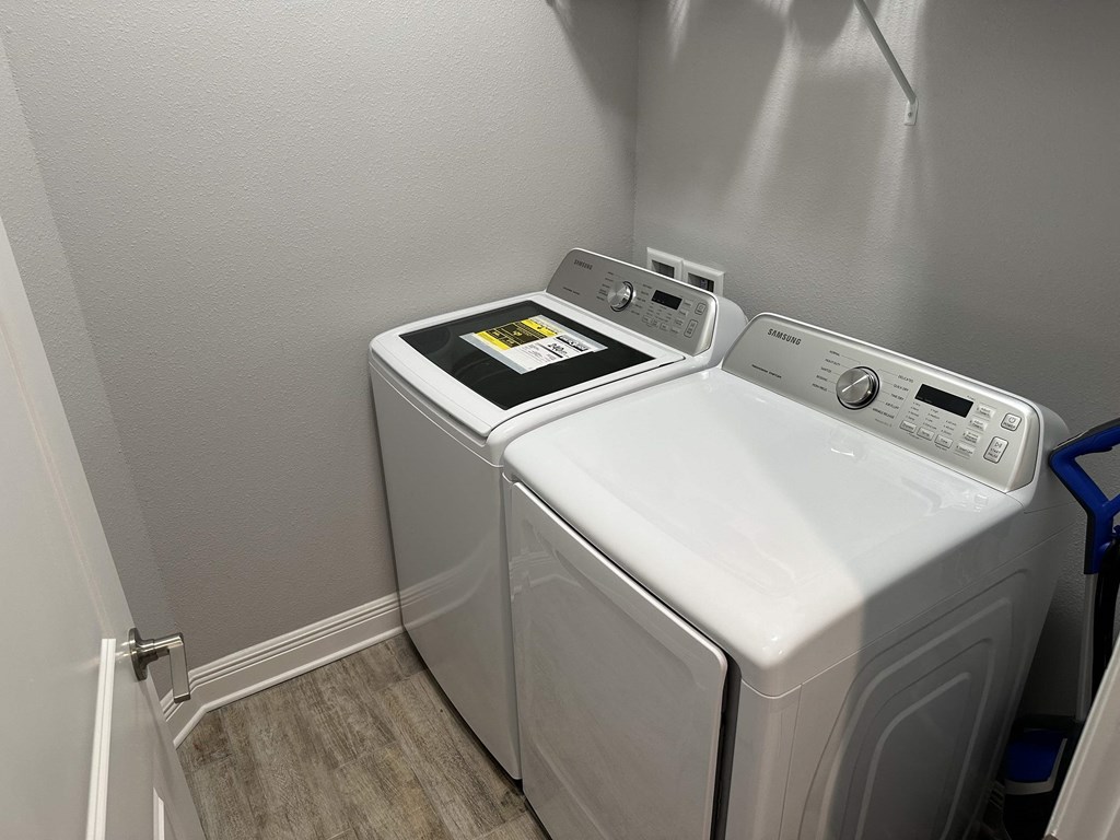 a washer and dryer in a laundry room with gray walls